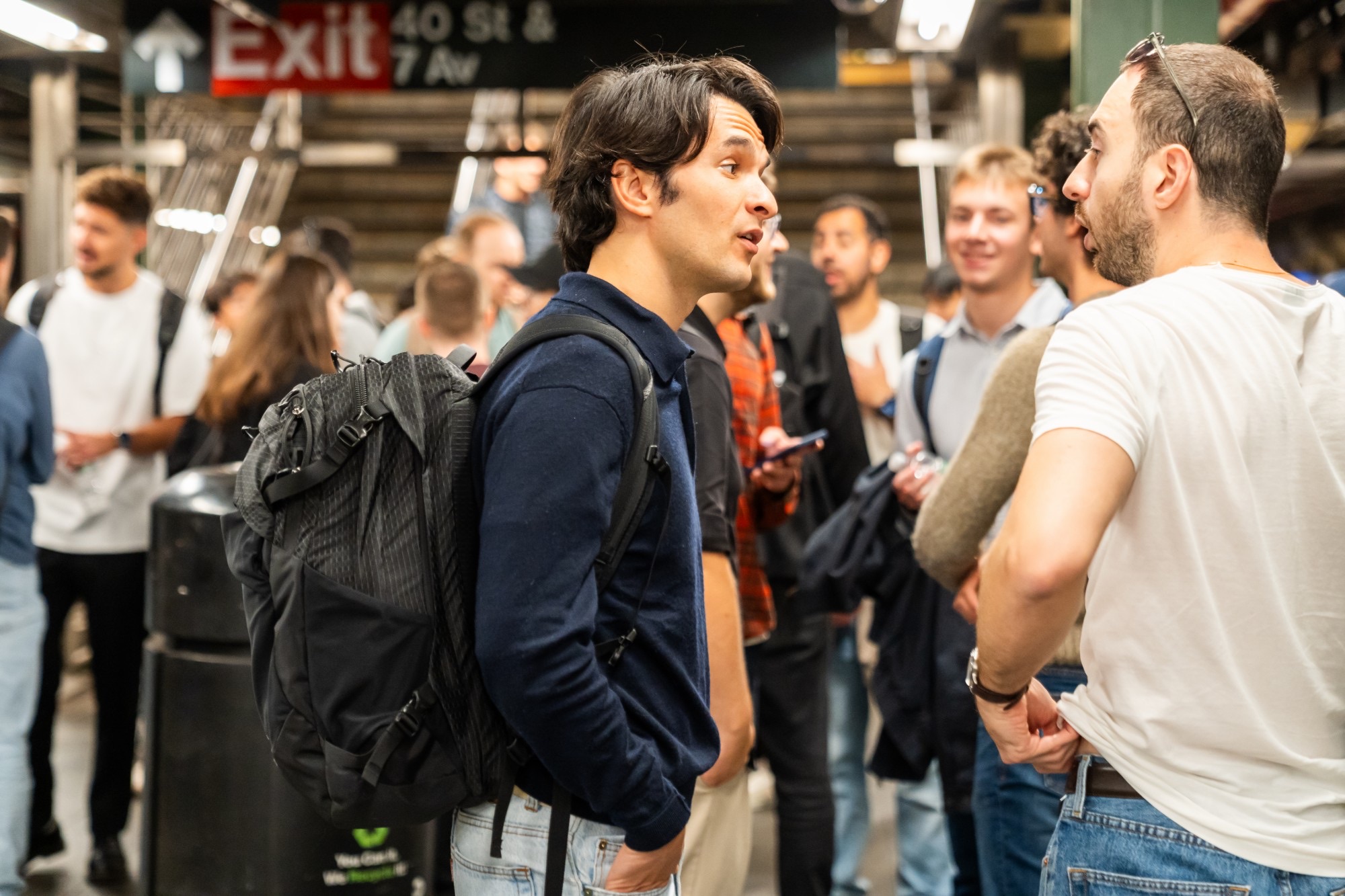 CamelHack participants talking with a speaker in a New York subway station